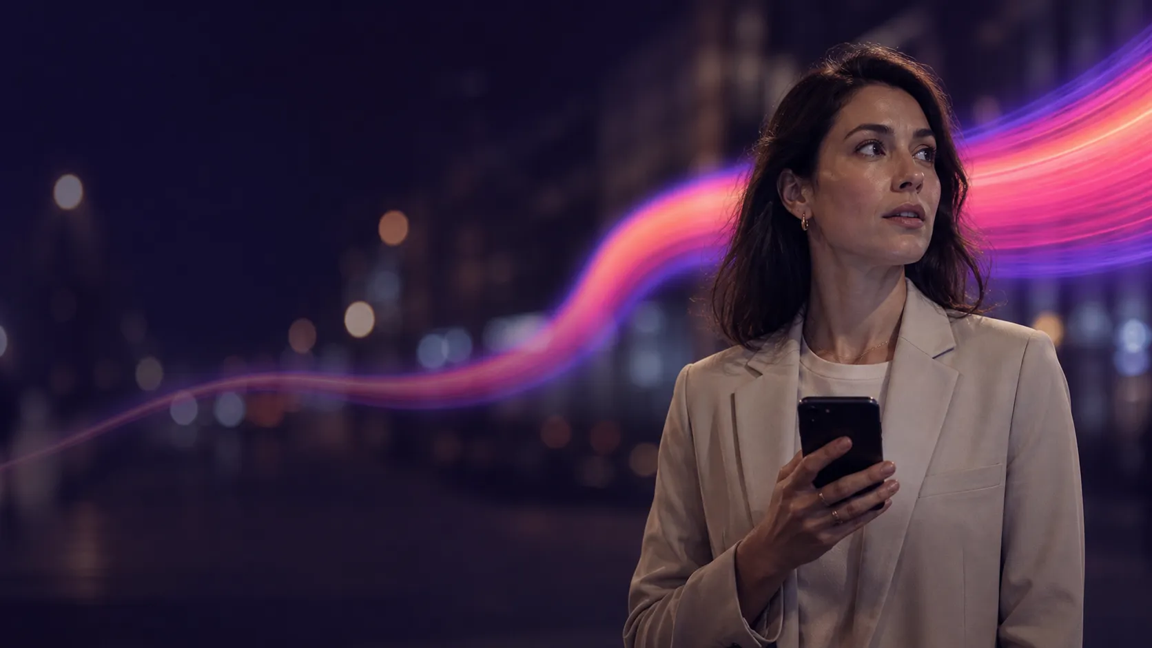 A woman in a light blazer on a city street at night holding a mobile phone, the street behind her in deep bokeh, with a glowing violet and magenta ribbon passing behind her
